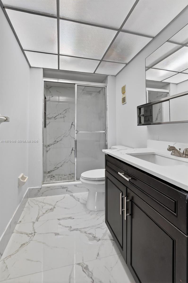 450 Northwest 20th Street, Unit 2120 Boca Raton, FL 33431 - Photo 14 of 27 a bathroom with a sink a toilet and shower