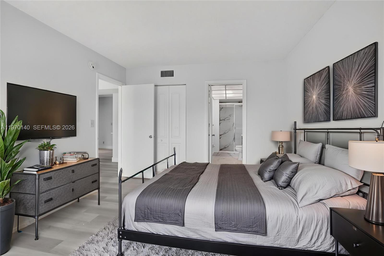 450 Northwest 20th Street, Unit 2120 Boca Raton, FL 33431 - Photo 15 of 27 a bedroom with a bed and a flat screen tv