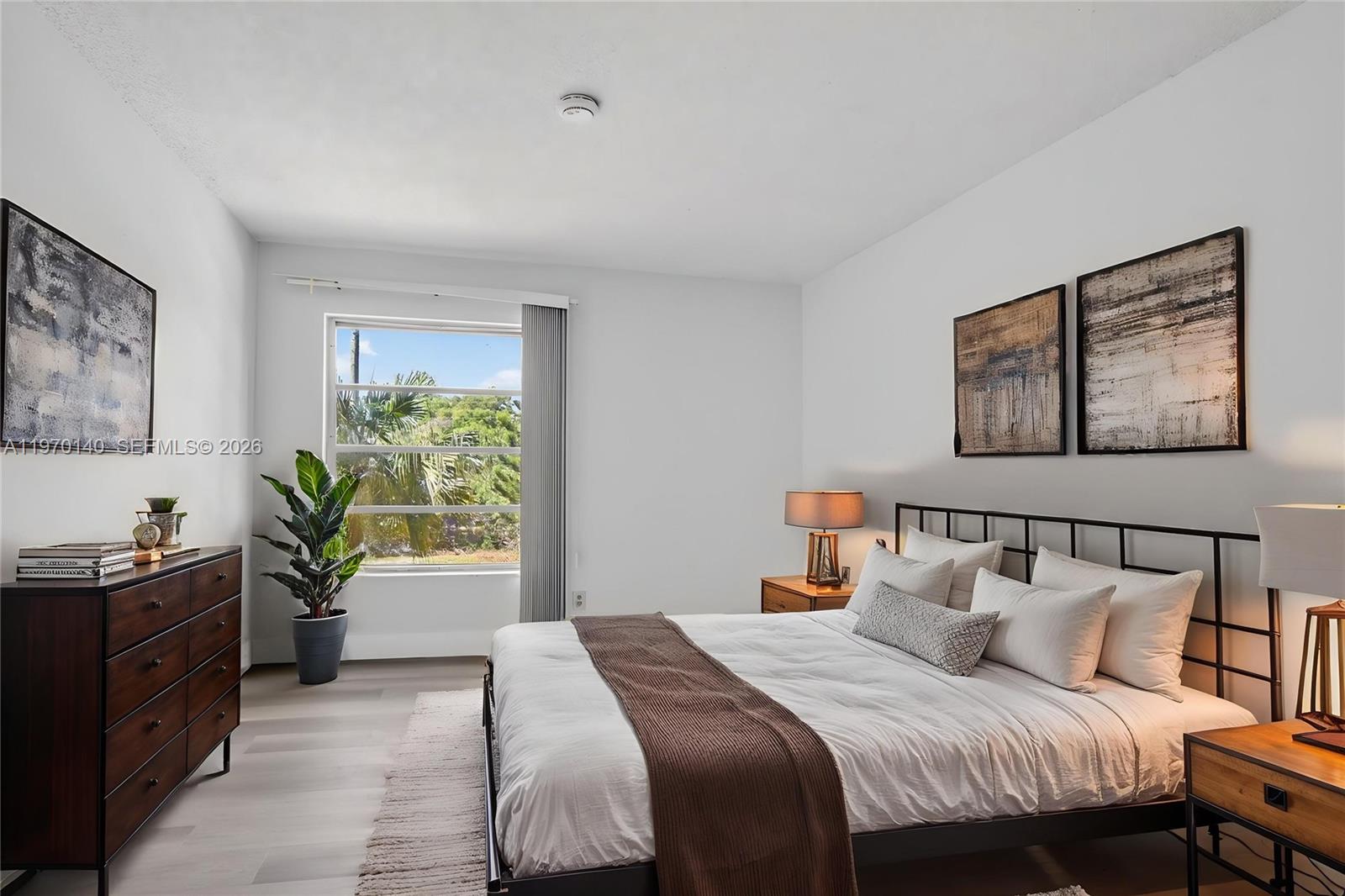 450 Northwest 20th Street, Unit 2120 Boca Raton, FL 33431 - Photo 16 of 27 a bedroom with a bed and a potted plant on a dresser