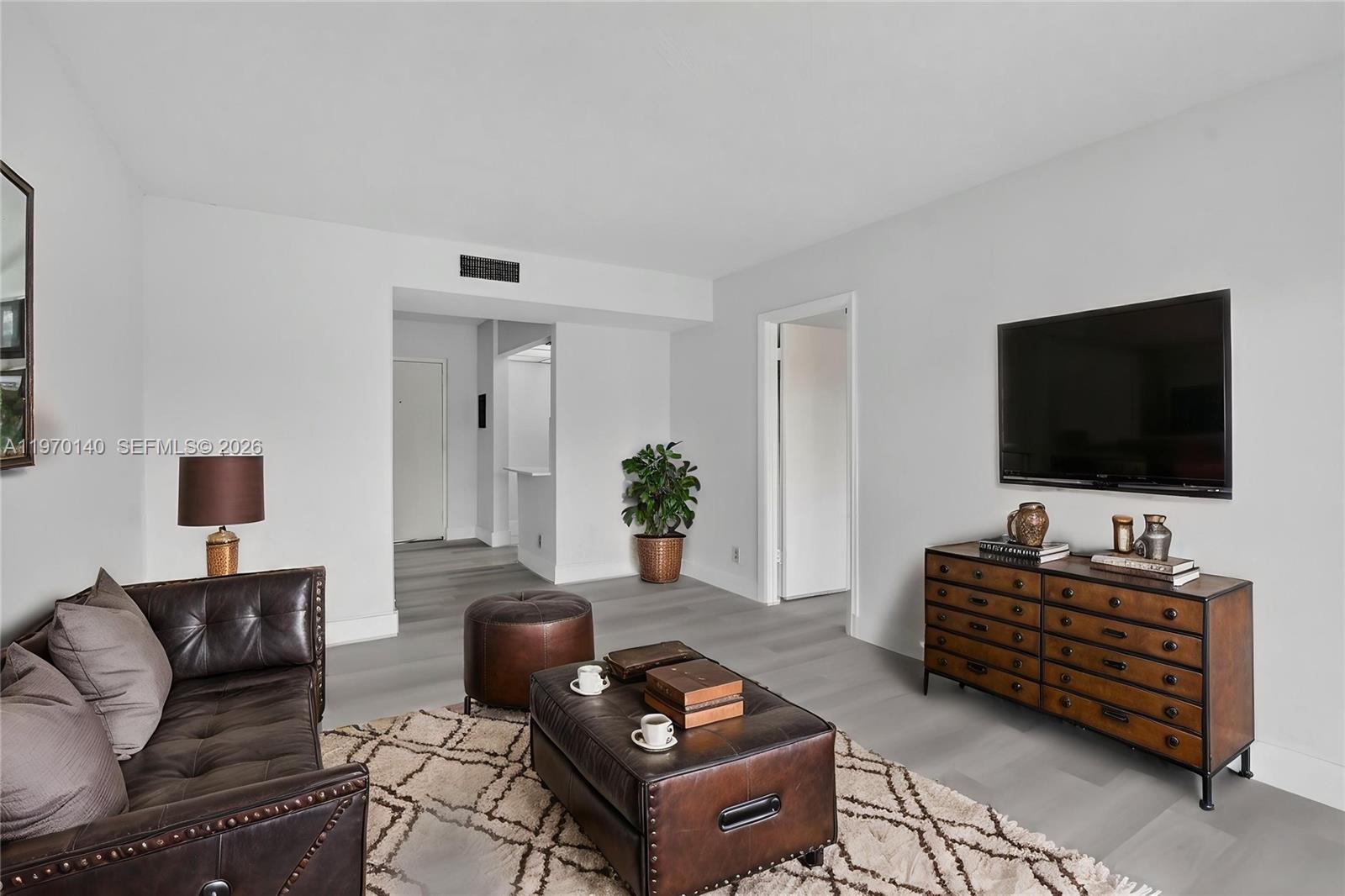 450 Northwest 20th Street, Unit 2120 Boca Raton, FL 33431 - Photo 19 of 27 a living room with furniture and a flat screen tv