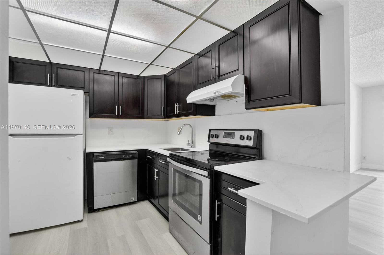 450 Northwest 20th Street, Unit 2120 Boca Raton, FL 33431 - Photo 2 of 27 a kitchen with stainless steel appliances granite countertop a sink and a refrigerator