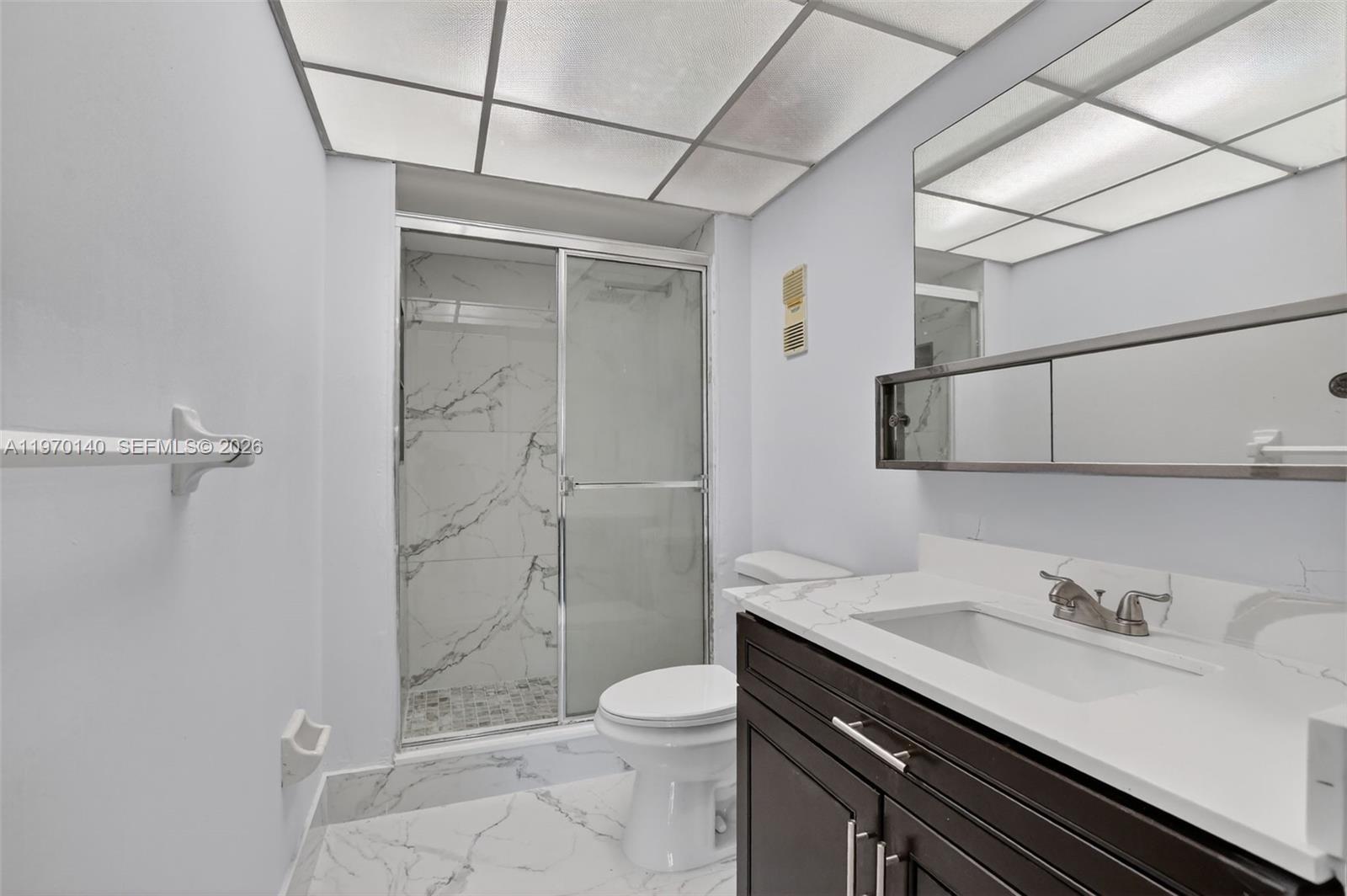 450 Northwest 20th Street, Unit 2120 Boca Raton, FL 33431 - Photo 3 of 27 a bathroom with a granite countertop sink toilet and shower