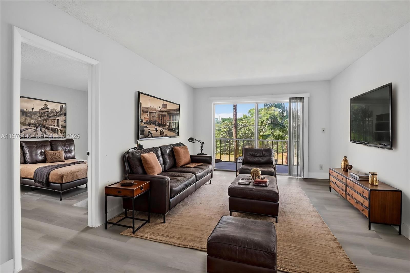 450 Northwest 20th Street, Unit 2120 Boca Raton, FL 33431 - Photo 5 of 27 a living room with furniture and a flat screen tv