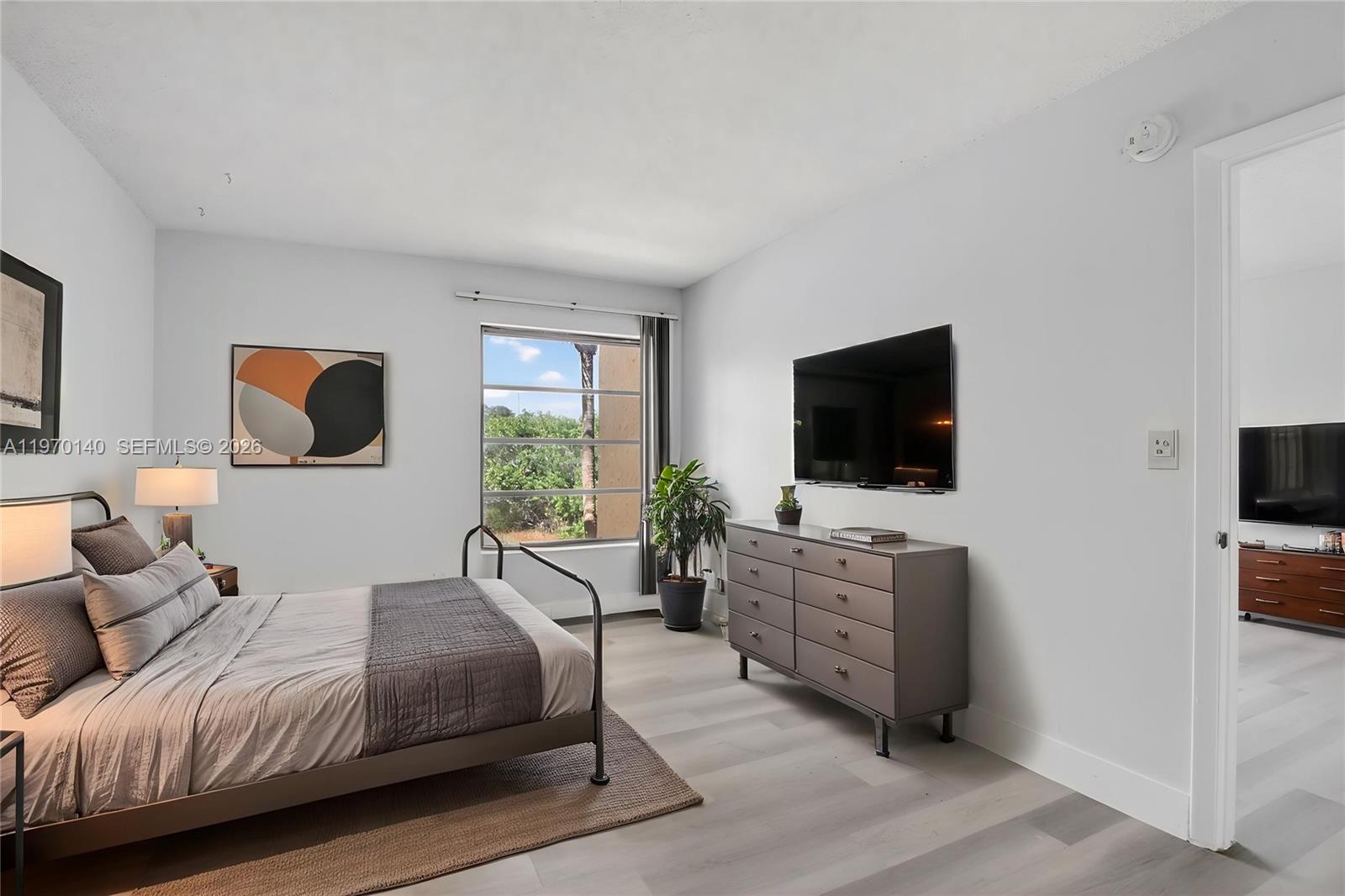 450 Northwest 20th Street, Unit 2120 Boca Raton, FL 33431 - Photo 7 of 27 a bedroom with a bed and a flat screen tv