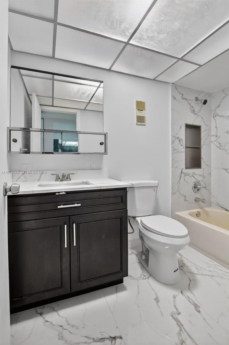 450 Northwest 20th Street, Unit 2120 Boca Raton, FL 33431 - Photo 9 of 27 a bathroom with a sink vanity granite toilet and shower