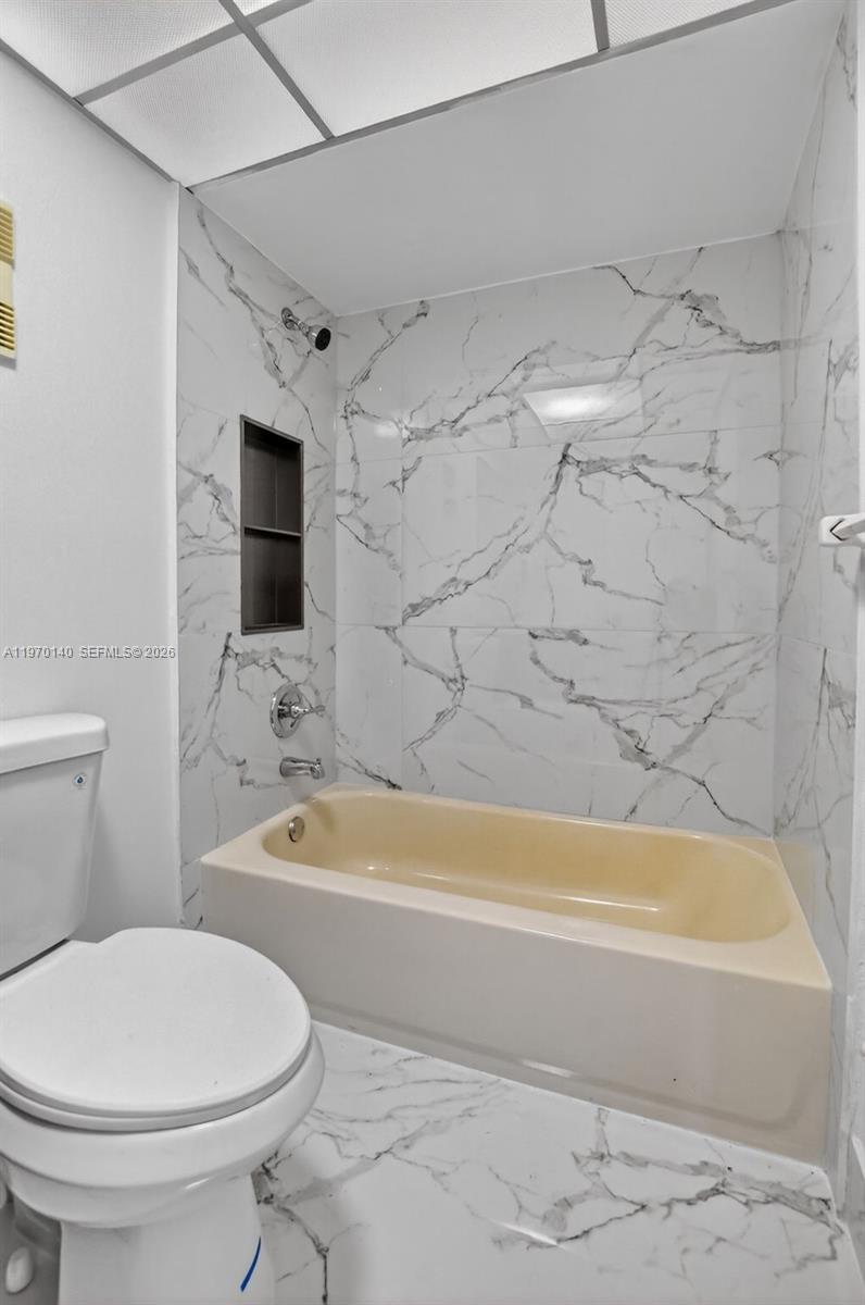 450 Northwest 20th Street, Unit 2120 Boca Raton, FL 33431 - Photo 10 of 27 a bathroom with a toilet and a bathtub