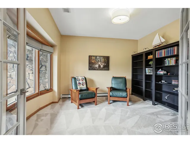 a living room with furniture cabinets and window