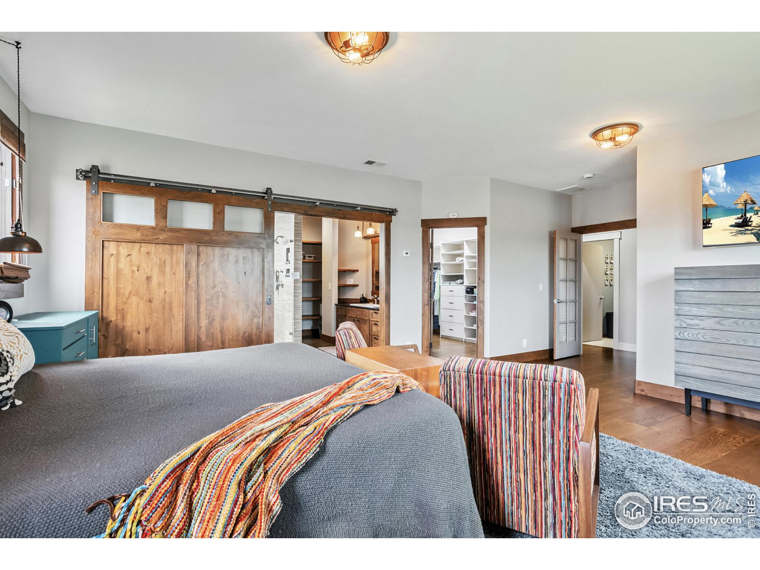 3310 Routt Street Wheat Ridge, CO 80033 - Photo 17 of 35 a bedroom with a bed and wooden floor