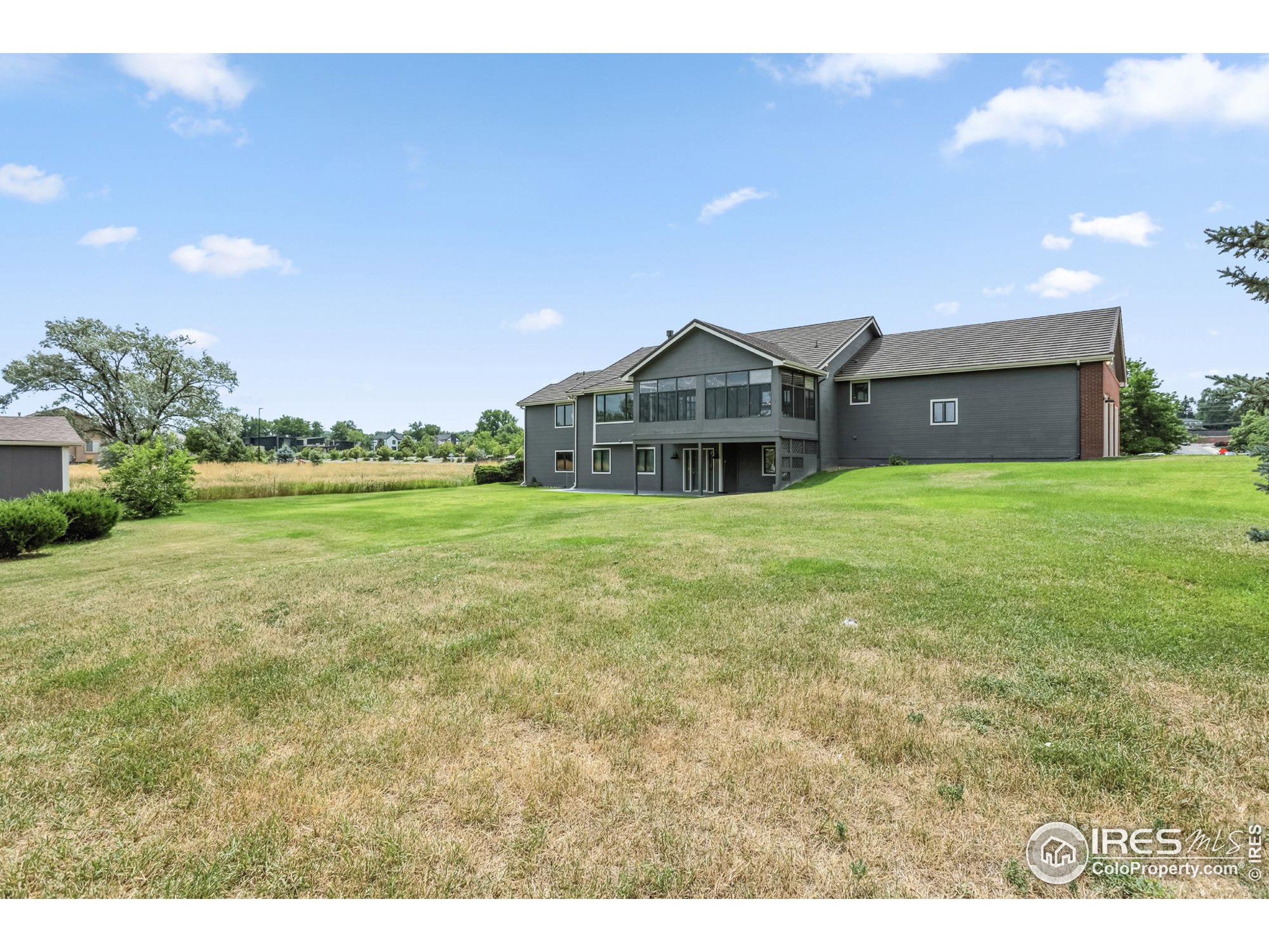 3310 Routt Street Wheat Ridge, CO 80033 - Photo 33 of 35 a view of a house with a yard and garage