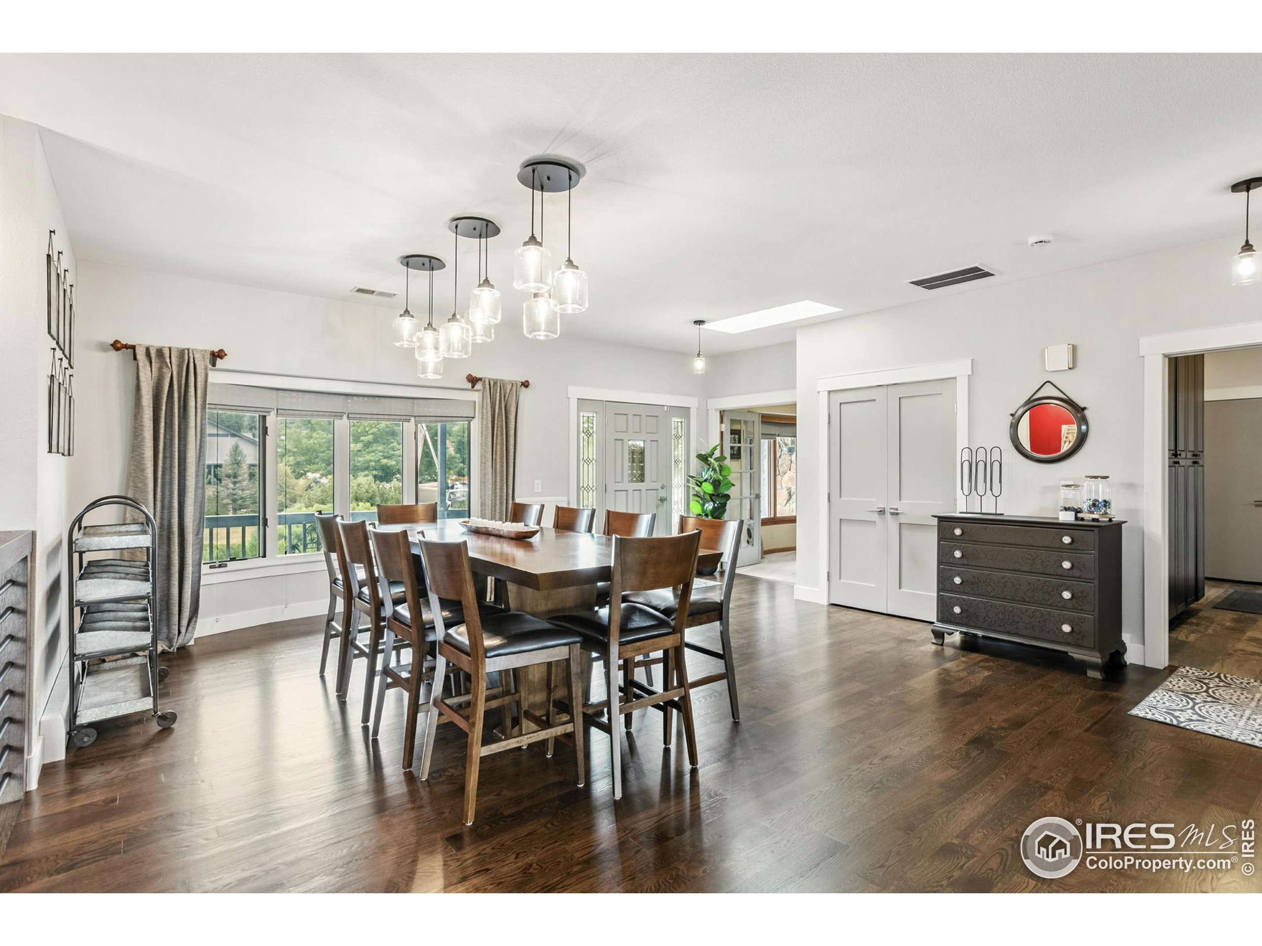 3310 Routt Street Wheat Ridge, CO 80033 - Photo 4 of 35 a view of a dining room with furniture window and wooden floor