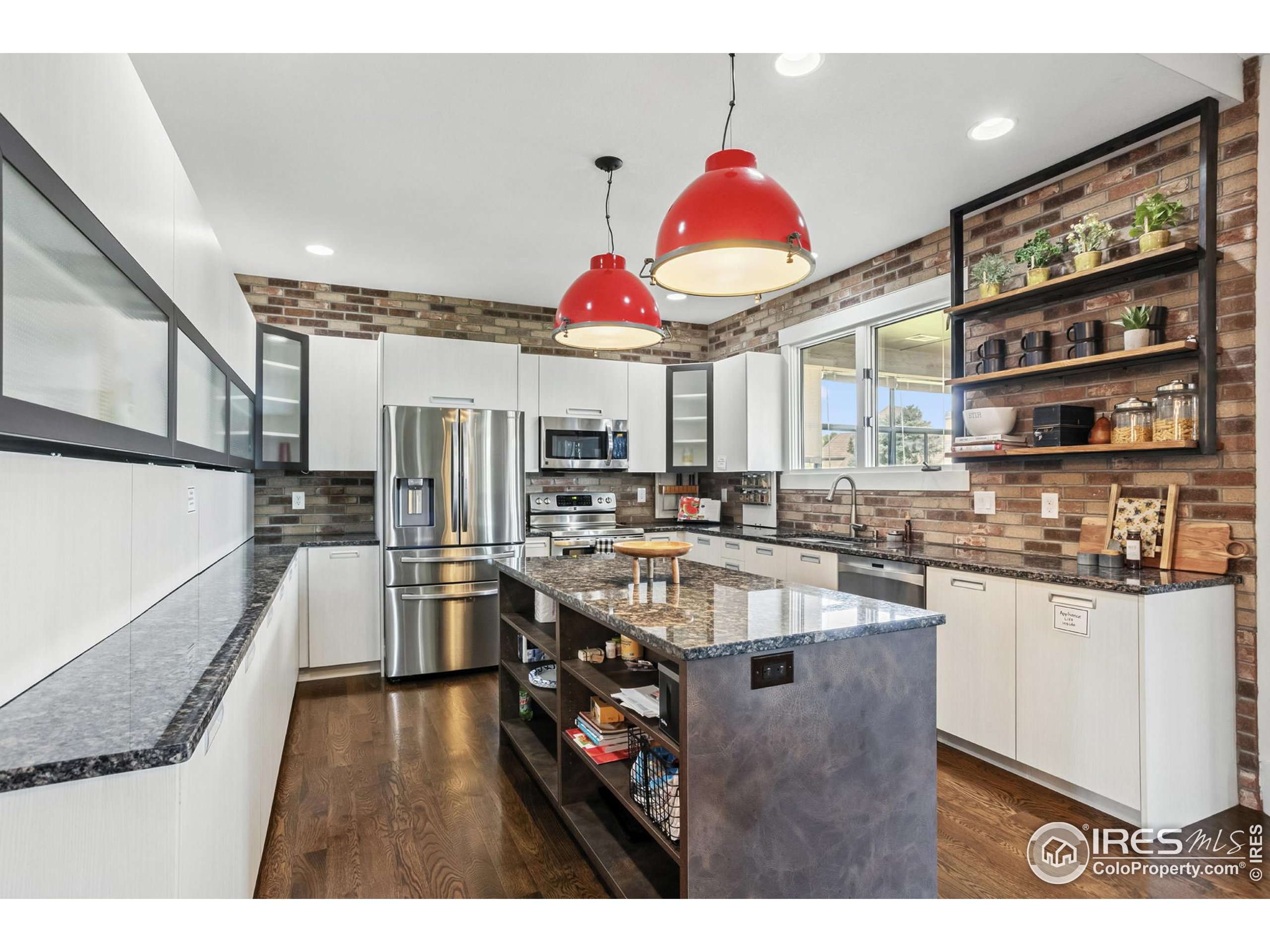 3310 Routt Street Wheat Ridge, CO 80033 - Photo 7 of 35 a kitchen with stainless steel appliances granite countertop a sink a stove and a refrigerator