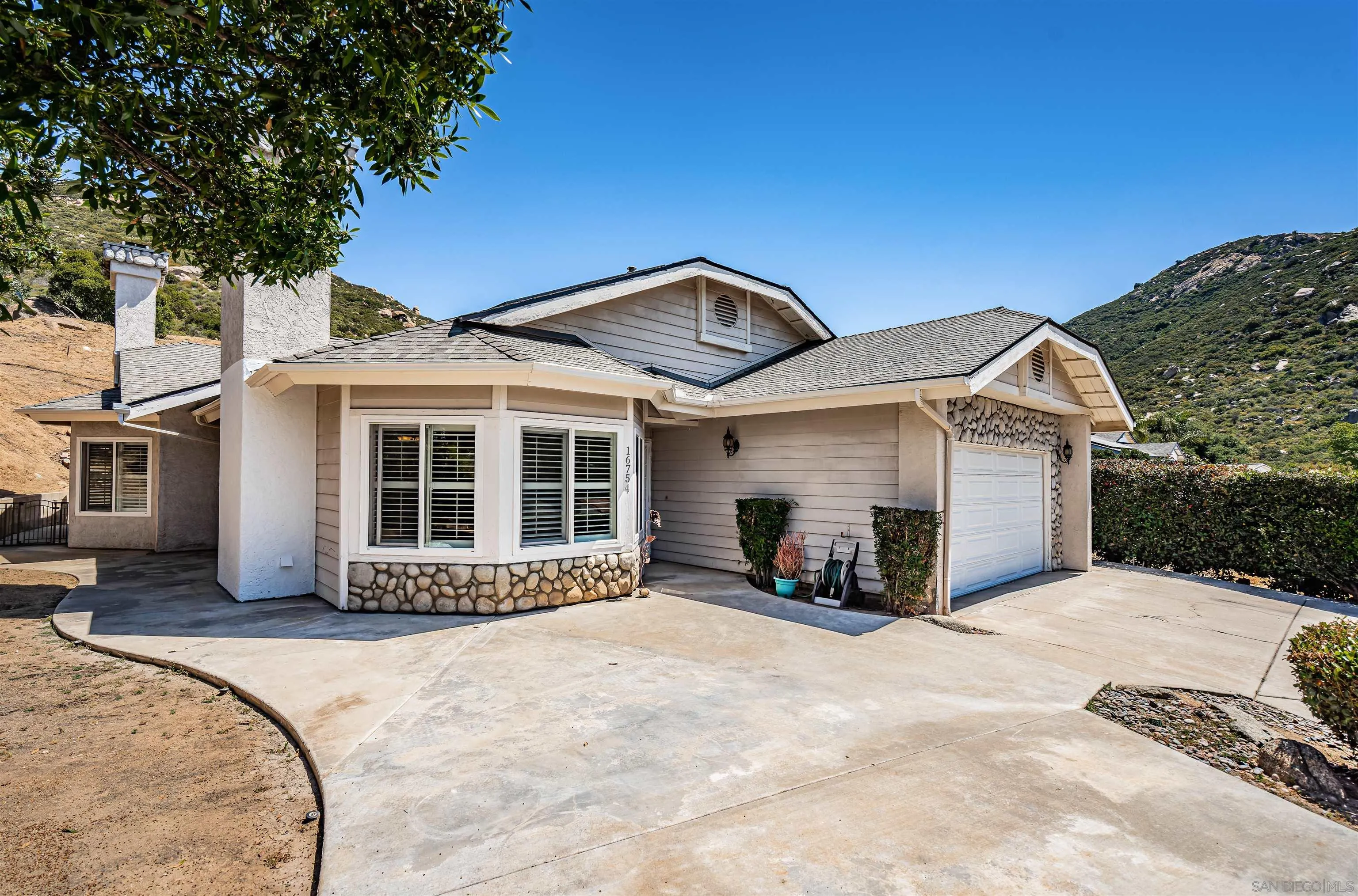 16754 Georgios Way Ramona, CA 92065 - Photo 2 of 29 a front view of a house with a yard