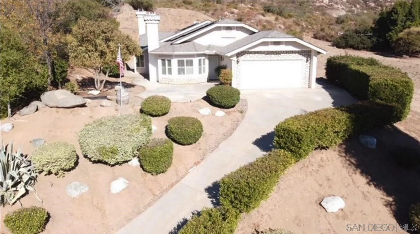 16754 Georgios Way Ramona, CA 92065 - Photo 3 of 29 a bathroom with a sink mirror and vanity