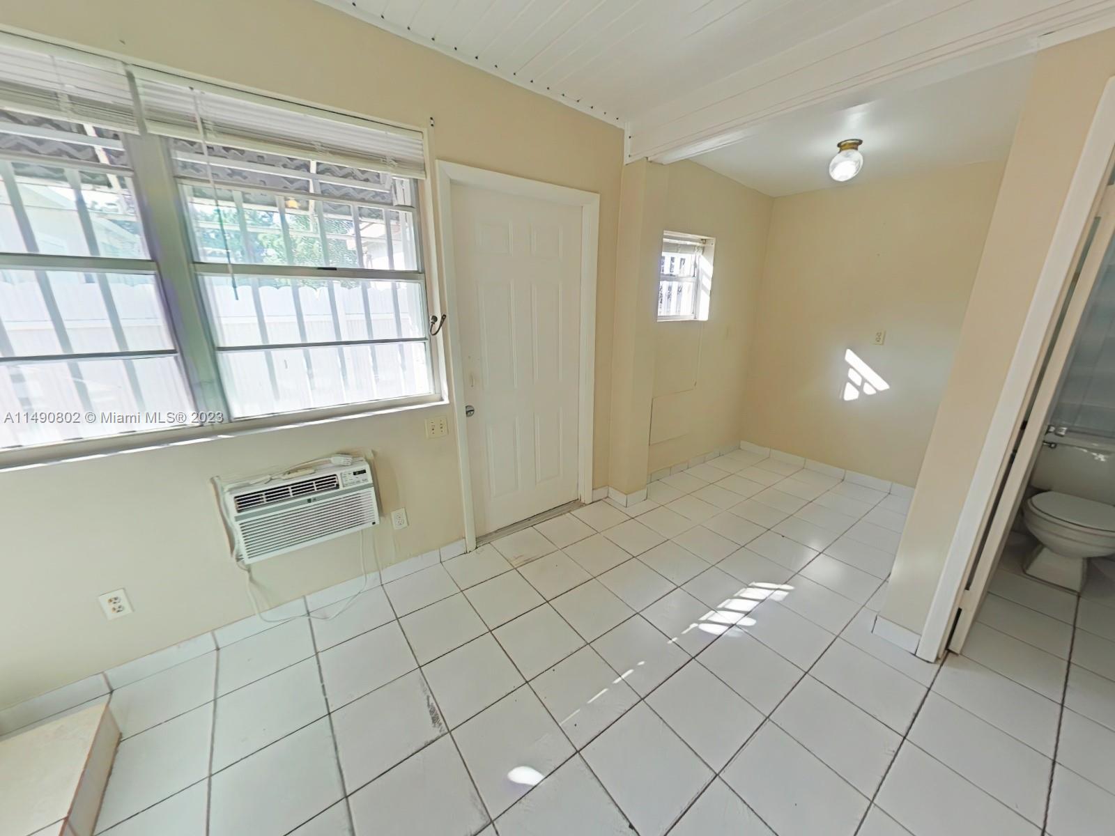 5643 Southwest 7th Street Miami, FL 33144 - Photo 13 of 25 a view of an empty room with windows