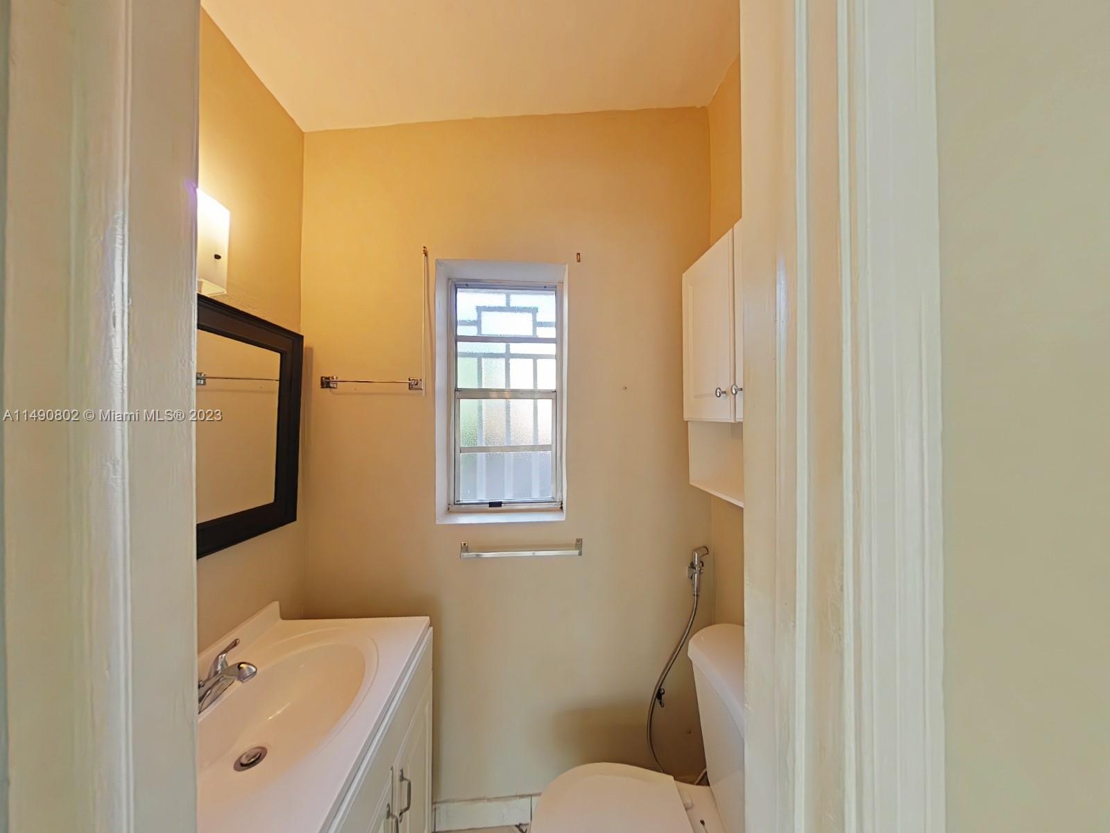 5643 Southwest 7th Street Miami, FL 33144 - Photo 14 of 25 a bathroom with a sink and a toilet