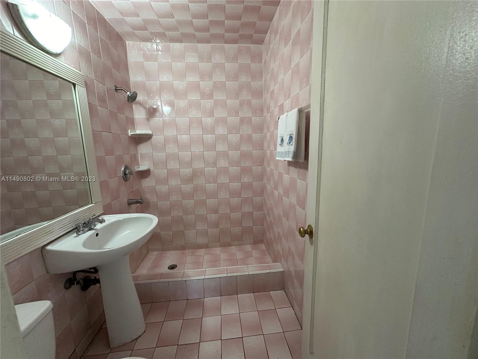 5643 Southwest 7th Street Miami, FL 33144 - Photo 5 of 25 a bathroom with a sink a toilet and shower