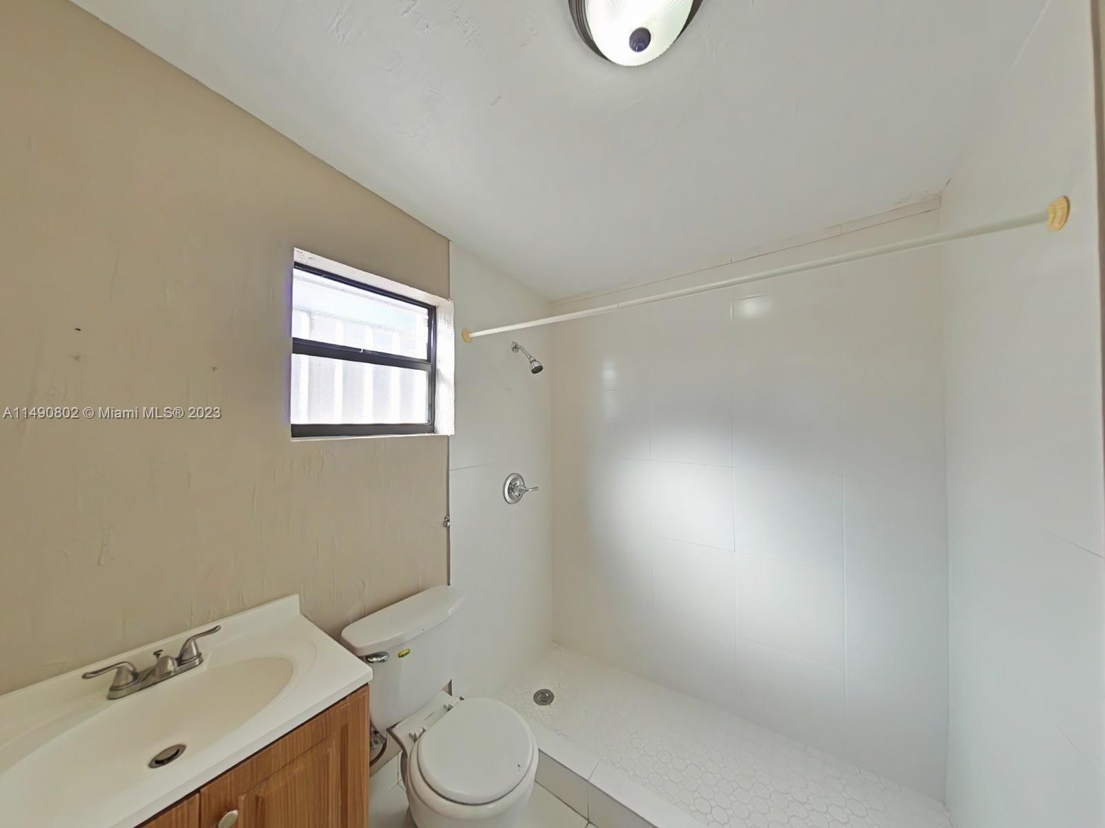 5643 Southwest 7th Street Miami, FL 33144 - Photo 9 of 25 a bathroom with a sink toilet and shower