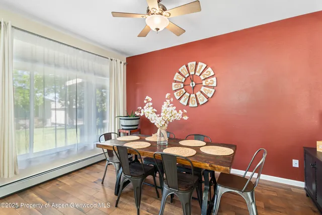 a view of a dining room with furniture and wooden floor