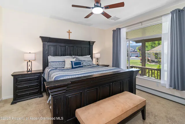 a bedroom with a bed window and a ceiling fan