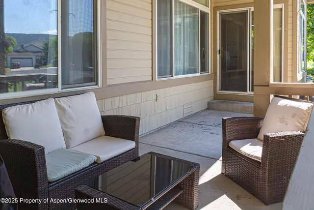a view of a patio with couches chairs and potted plants