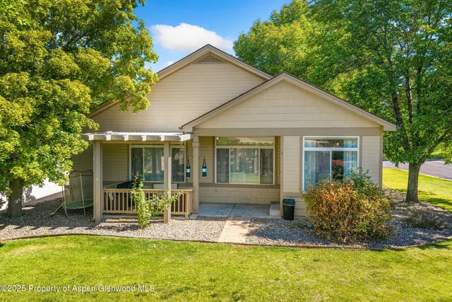 a view of a house with backyard porch and sitting area