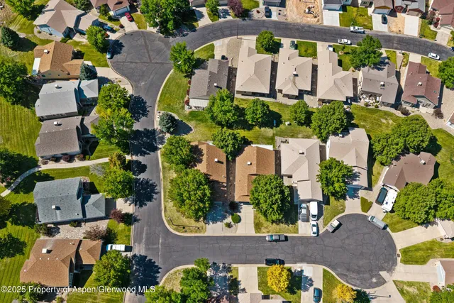 an aerial view of a house with a swimming pool