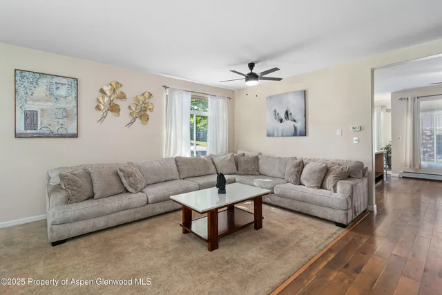 a living room with furniture and a large window