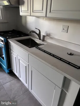 a kitchen with a sink and cabinets