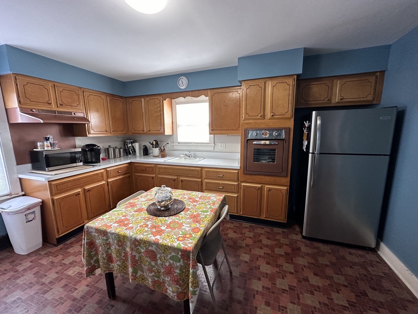 14050 Agnew Road Sterling, IL 61081 - Photo 14 of 27 a kitchen with granite countertop a refrigerator a sink a stove a microwave a dining table and chairs with wooden floor