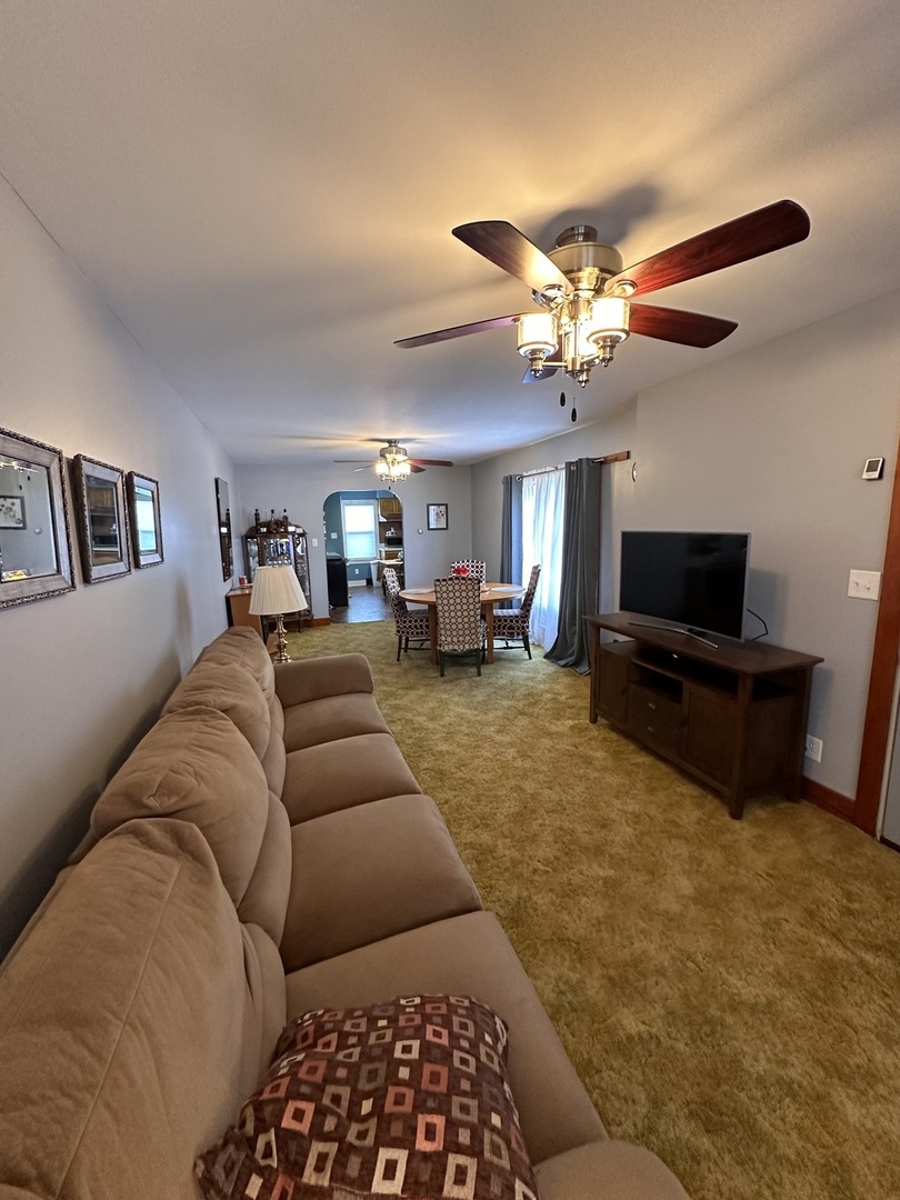 14050 Agnew Road Sterling, IL 61081 - Photo 18 of 27 a living room with furniture and a flat screen tv