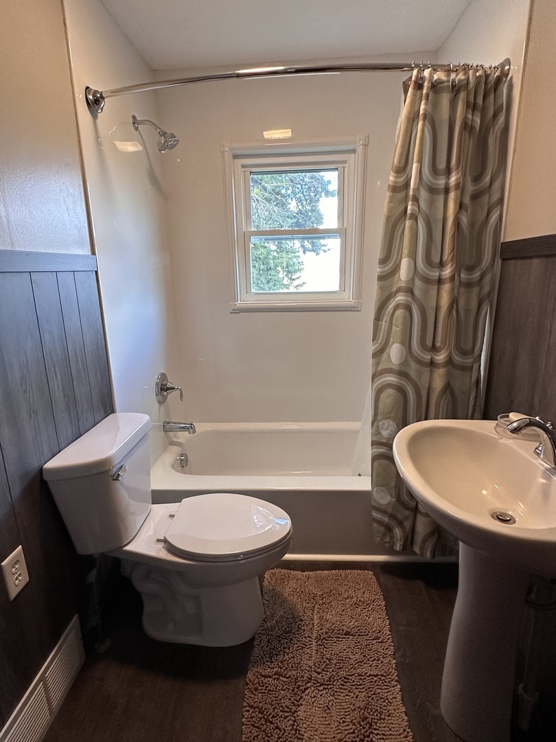 14050 Agnew Road Sterling, IL 61081 - Photo 19 of 27 a bathroom with a sink a toilet a mirror and shower