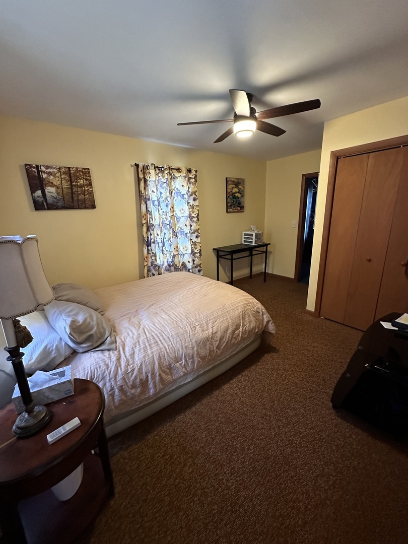 14050 Agnew Road Sterling, IL 61081 - Photo 21 of 27 a bedroom with a bed and a ceiling fan