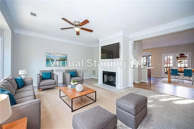 a living room with furniture a fireplace and a flat screen tv