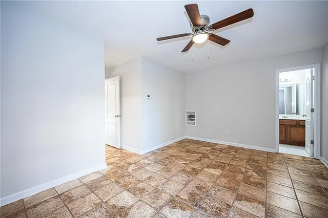 a view of a livingroom with a ceiling fan and window