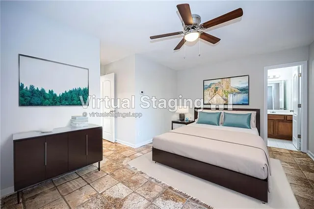 a bedroom with a large bed and a chandelier