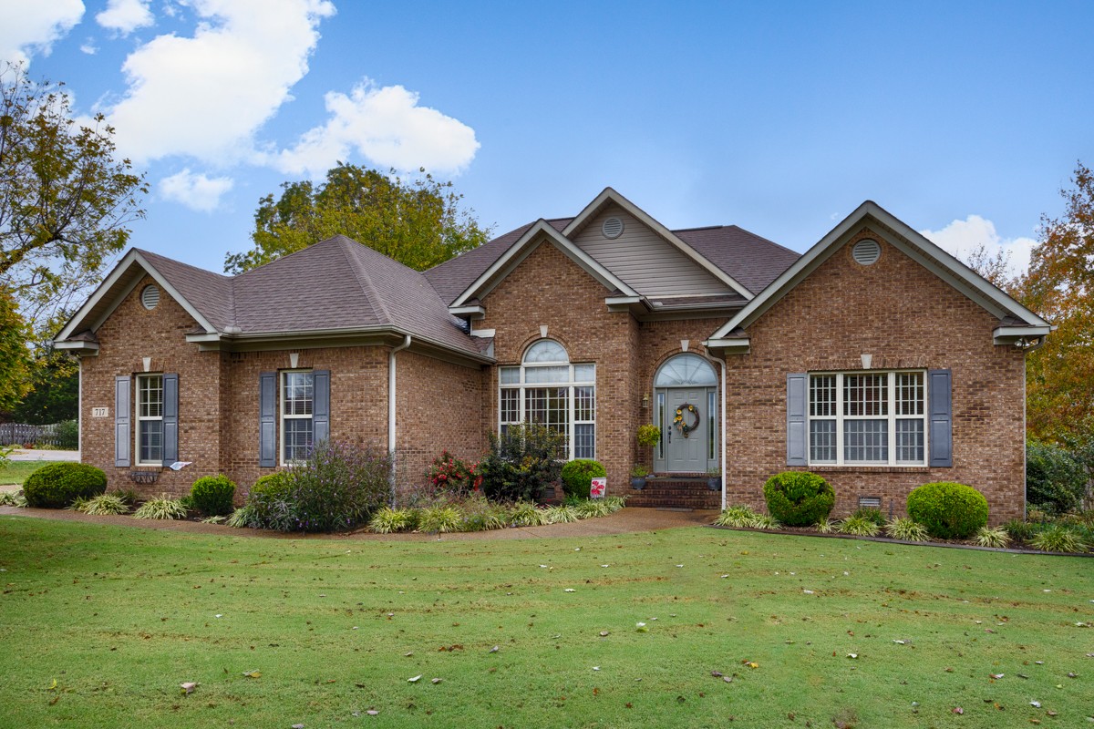 a front view of a house with a yard