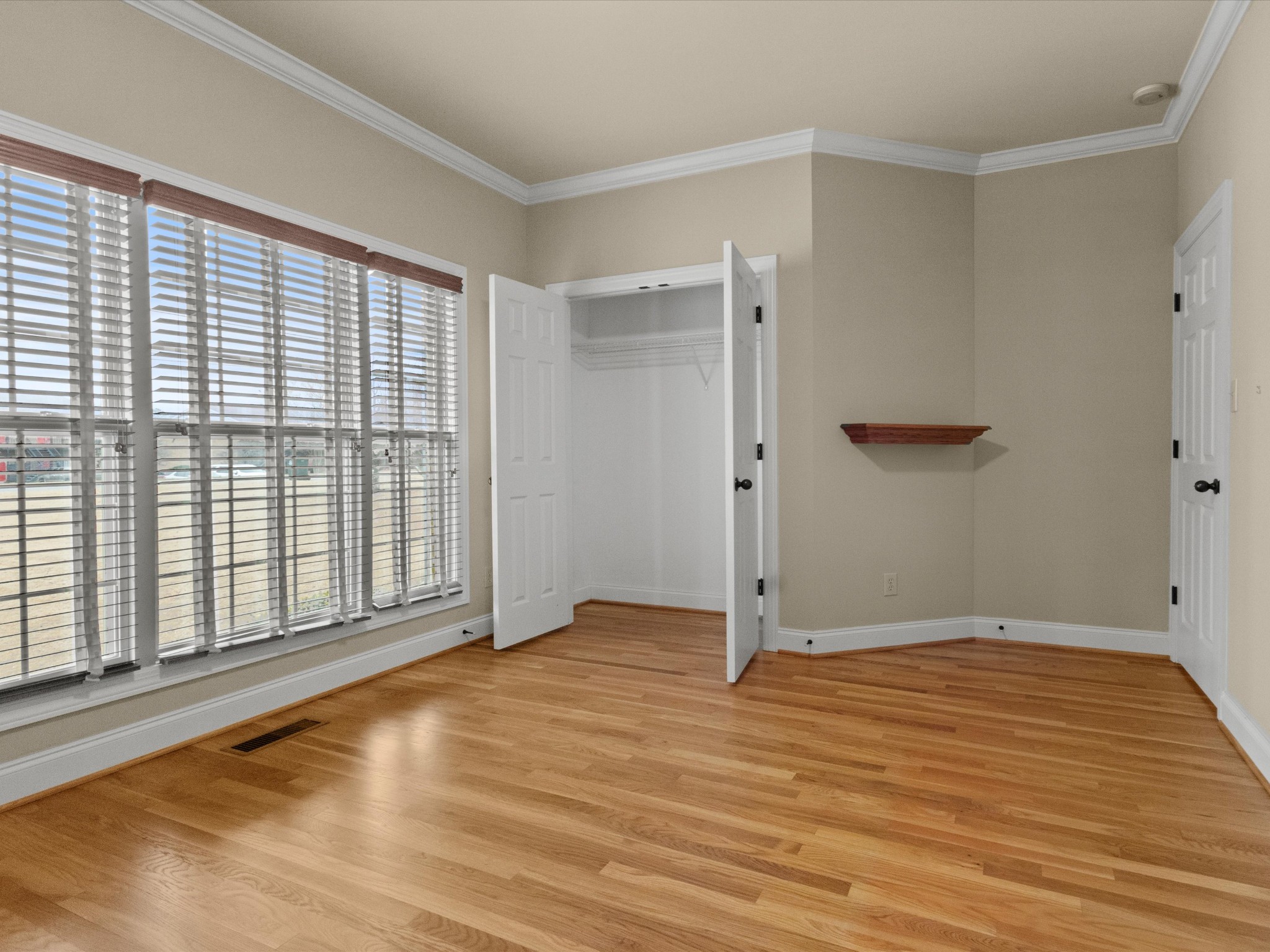 715 South Clinton Street Athens, AL 35611 - Photo 19 of 63 a view of an empty room with wooden floor and a window