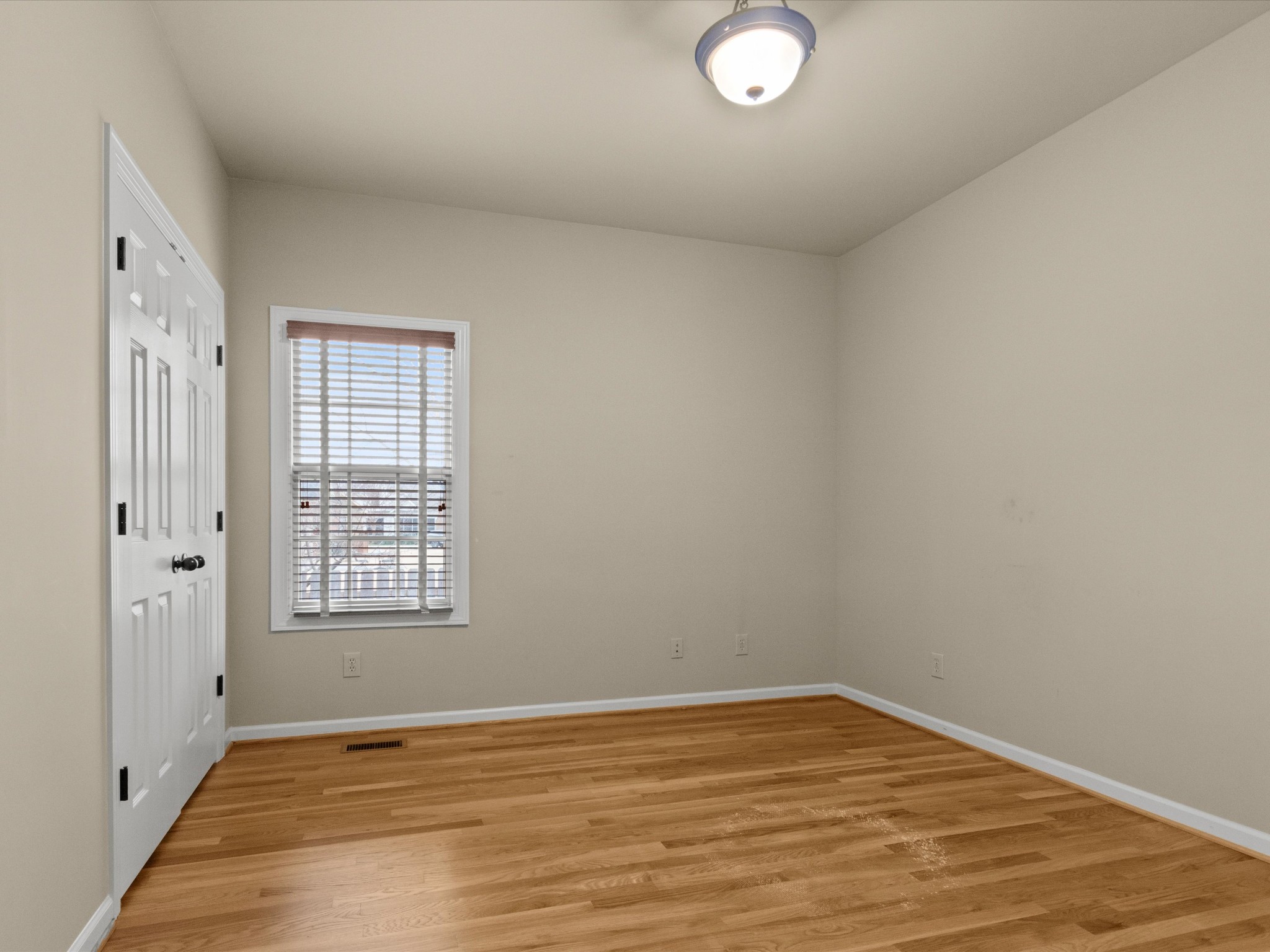 715 South Clinton Street Athens, AL 35611 - Photo 20 of 63 an empty room with wooden floor and windows