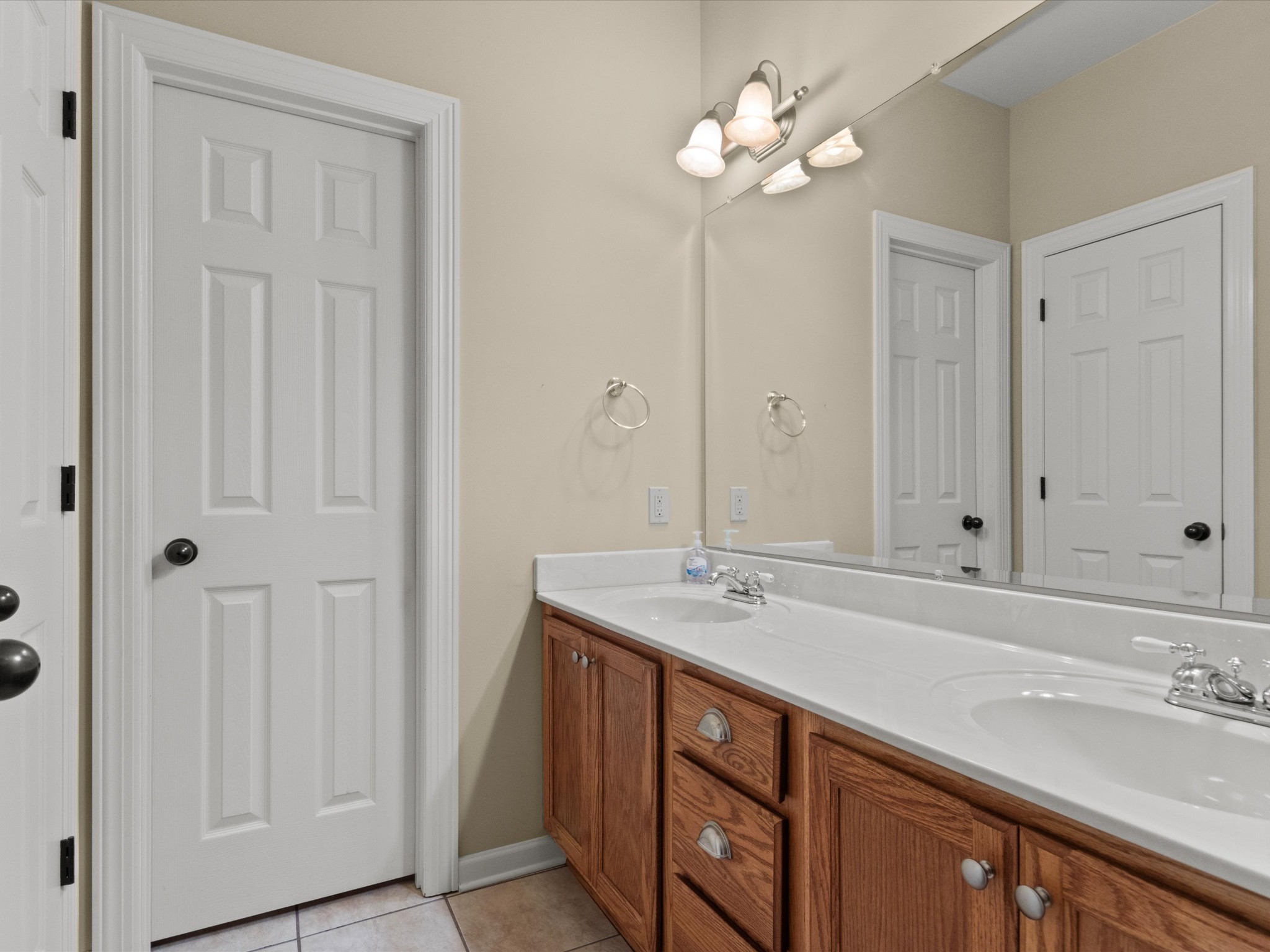 715 South Clinton Street Athens, AL 35611 - Photo 24 of 63 a bathroom with a sink double vanity and a mirror