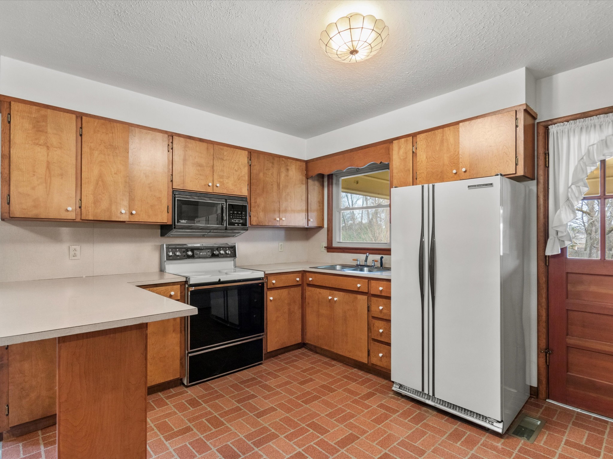715 South Clinton Street Athens, AL 35611 - Photo 42 of 63 a kitchen with stainless steel appliances granite countertop a refrigerator stove top oven and sink