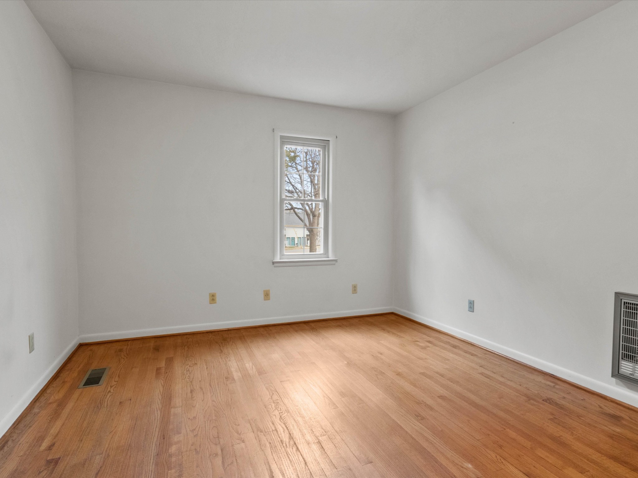 715 South Clinton Street Athens, AL 35611 - Photo 45 of 63 an empty room with wooden floor and windows