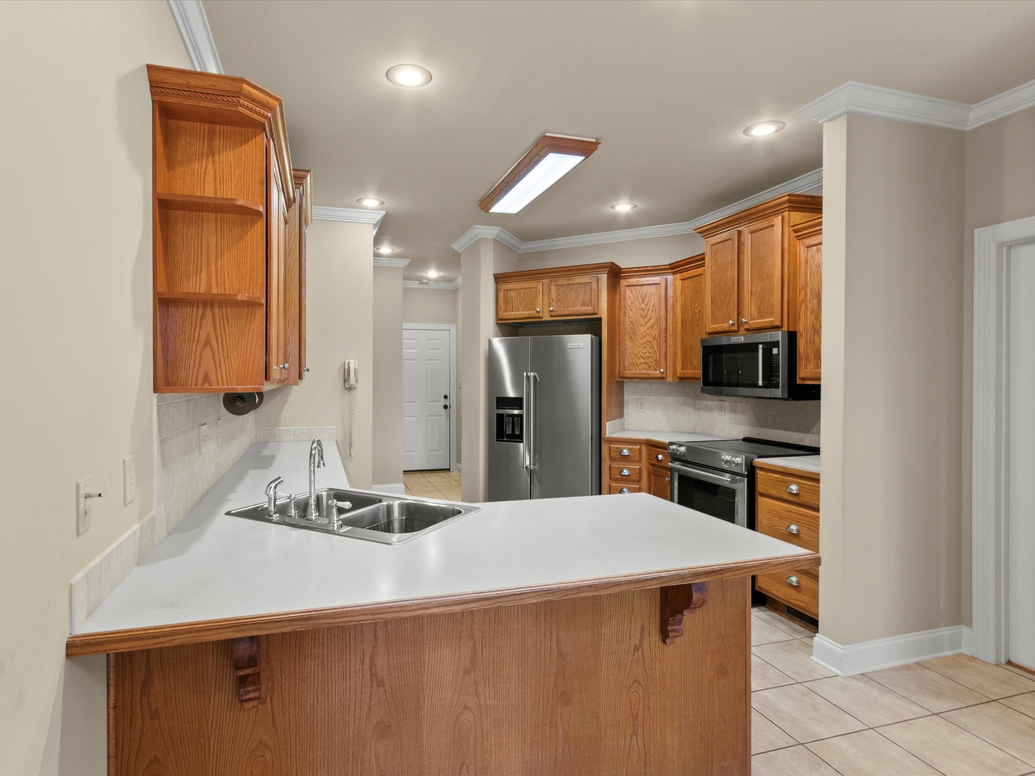 715 South Clinton Street Athens, AL 35611 - Photo 8 of 63 a kitchen with stainless steel appliances kitchen island granite countertop a sink refrigerator and cabinets