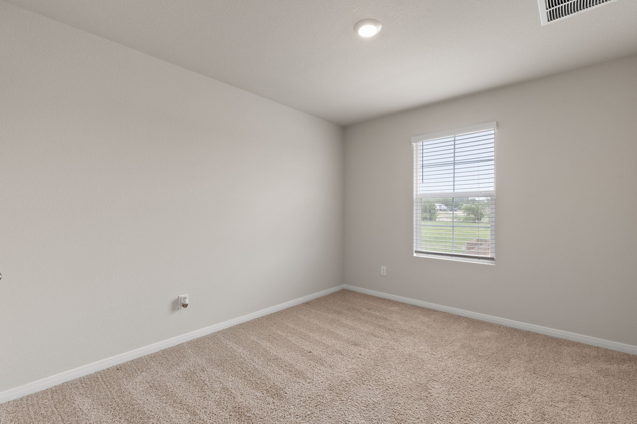 281 Jayden Drive Kyle, TX 78640 - Photo 26 of 36 Light-toned carpeted room featuring a single window with blinds, recessed ceiling lighting, and neutral wall tones