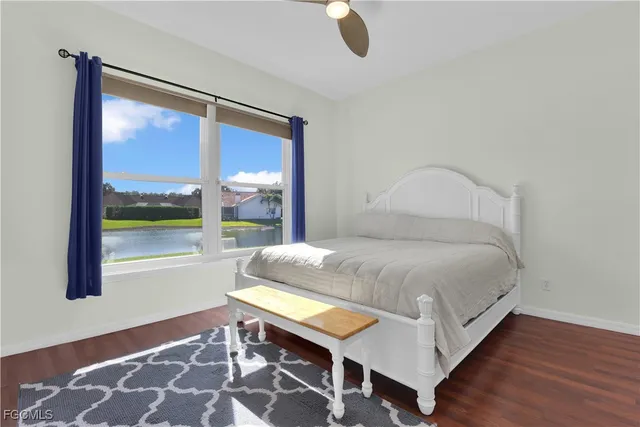 a view of a house with a big yard and large tree