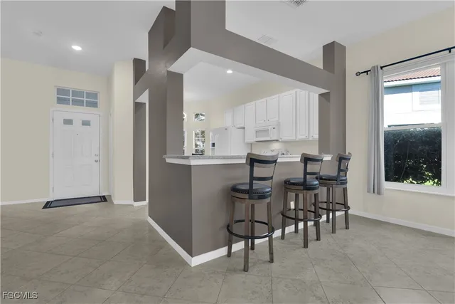 a kitchen with a stove top oven and white cabinets