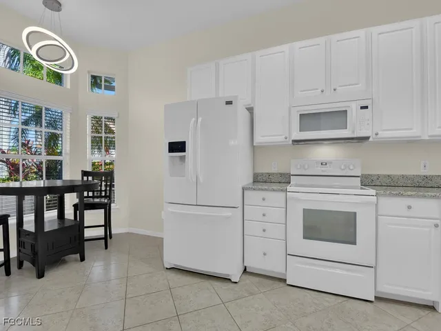 a view of a livingroom with furniture and an empty room