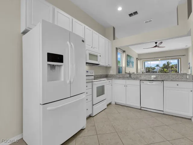 a view of a dining room with furniture and window