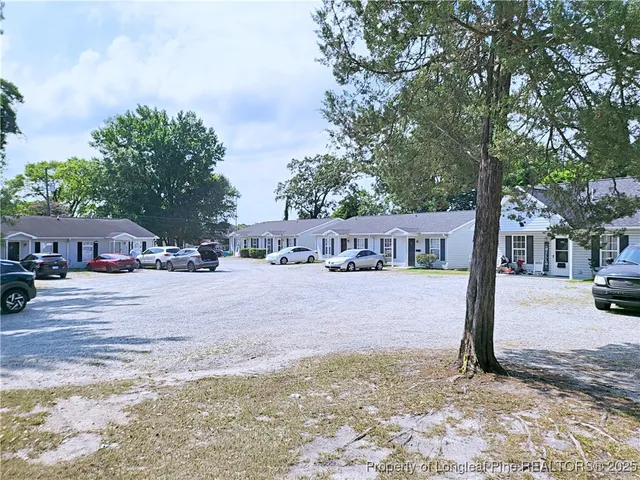 a front view of a building with trees
