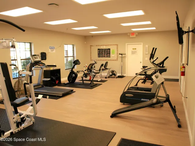 a view of a house with a door and wooden bench
