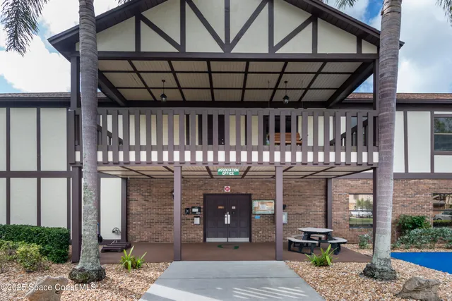 a view of a house with pool and chairs